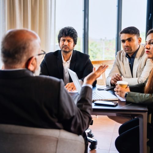 Indian asian Business professionals discussing ideas during a formal meeting in a conference room